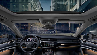 View from inside a car looking out to a city street, highlighting the vehicle's interior design.