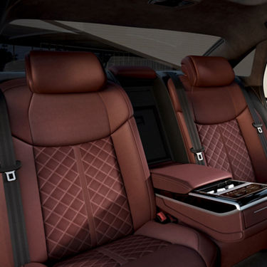 Car interior with quilted leather seats and modern design.