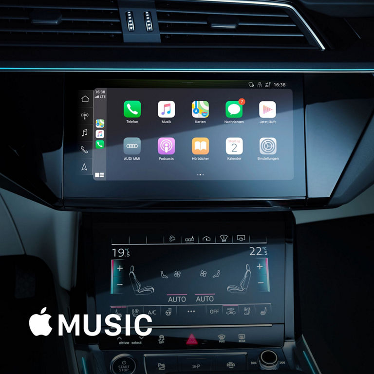 Car dashboard with Apple CarPlay on upper screen and climate controls on lower screen.