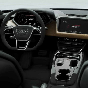 Interior view of an Audi car featuring the steering wheel, digital dashboard, and center console.