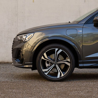 Side view of dark grey Audi Q3.