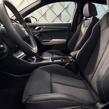 Inside view of Audi Q3 near modern architecture.