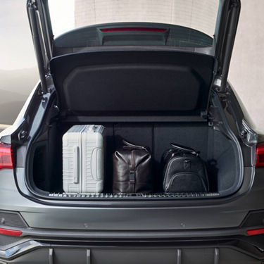 Audi Q3 with open boot and luggage in it.