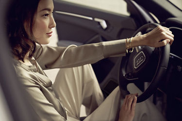 Lady with hands on the steering wheel inside an Audi Q3.