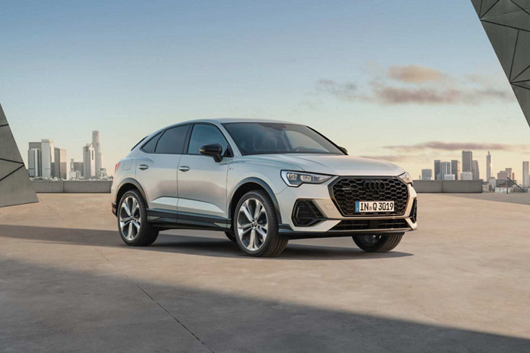 Silver Q3 Audi Sportback with city skyline in the background