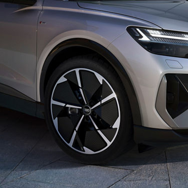 Close up of Audi Q4 Sportback front wheel with black trim.