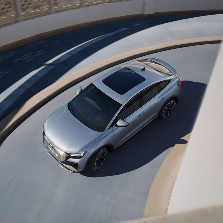 Ariel view of Audi A4 driving up a circular building.