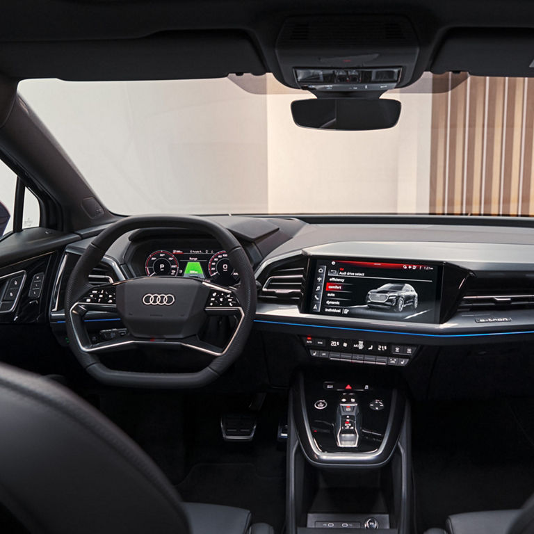 Interior view of an Audi car with digital dashboard and infotainment system.