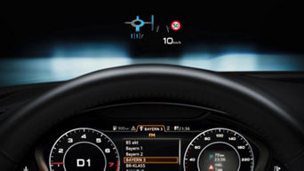 Car dashboard with digital display showing speed and various indicators.