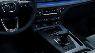 Interior of an Audi car showcasing the steering wheel, center console, and climate controls.