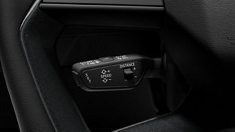 Close-up of a car's cruise control stalk on the steering column.