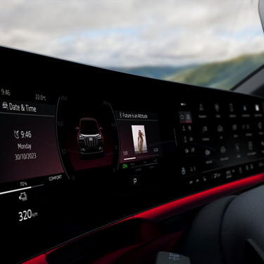 Car dashboard display with media control, vehicle status, and ambient lighting.