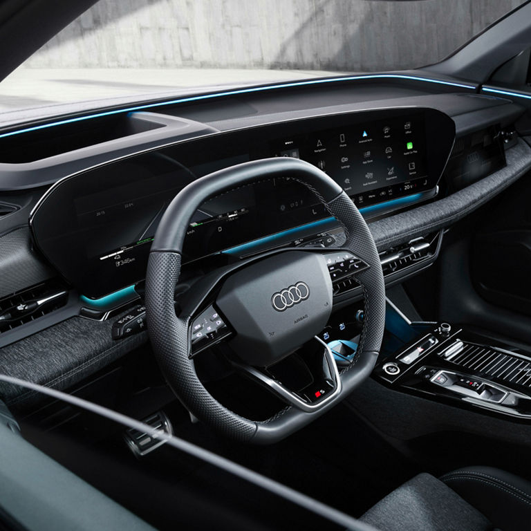 Interior view of a car with a digital dashboard and steering wheel.