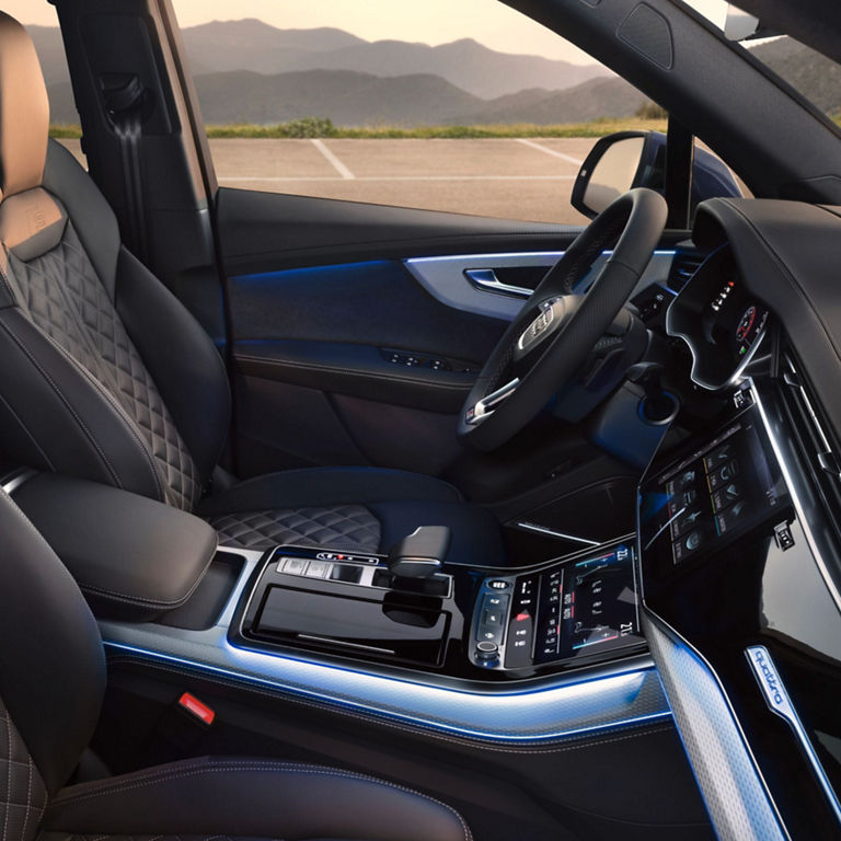 Car interior with leather seats, steering wheel, and modern dashboard.