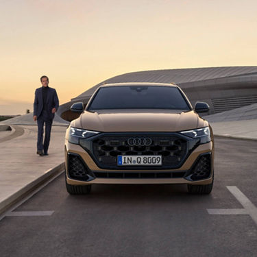  Audi Q8 parked in a bay with man a walking towards it.