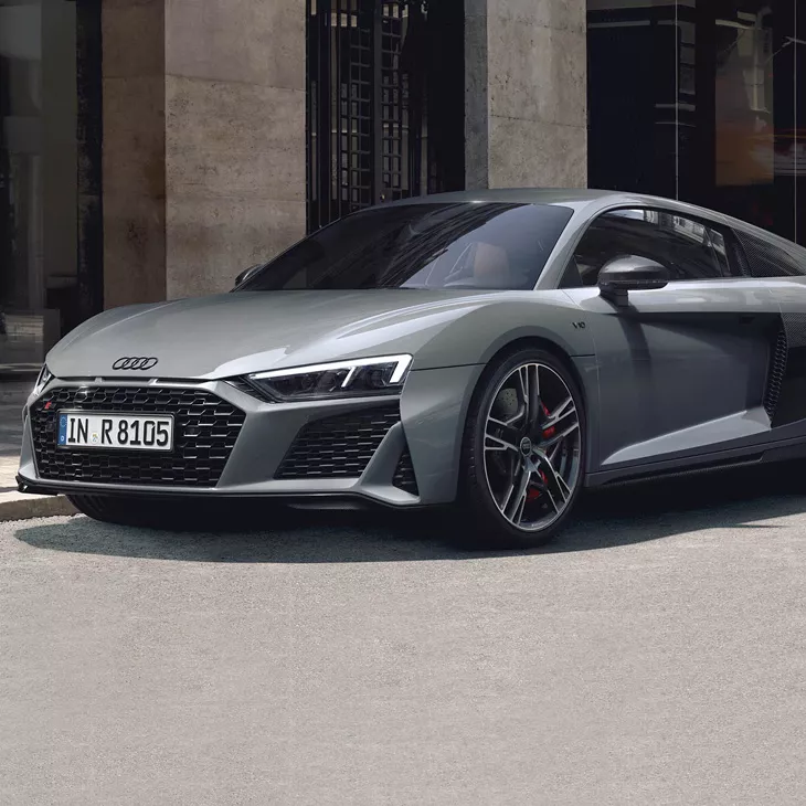 Silver Audi R8 Coupe parked on a city street.