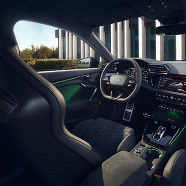  Interior view of an Audi RS3 Sportback car highlighting the steering wheel and dashboard.