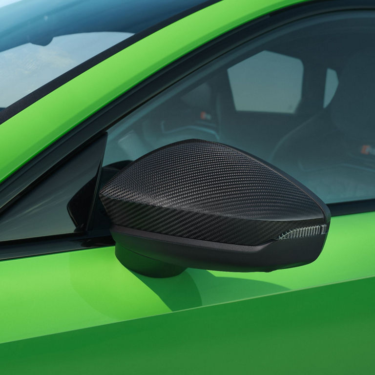  Carbon fiber side mirror on a bright green sports Audi RS3 Sportback.