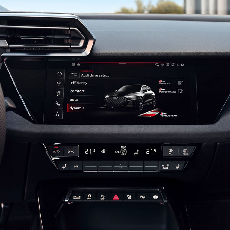 Audi RS3 Sportback car dashboard showing a touchscreen interface with 'Audi drive select' options and climate control settings.