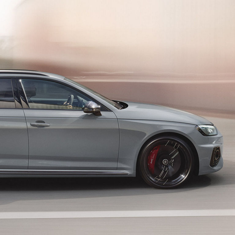 A hatchback car in motion, with a motion-blurred background.