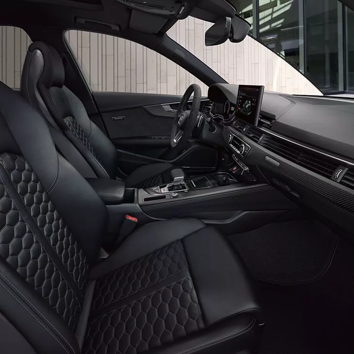 Car interior with black leather seats and modern dashboard.