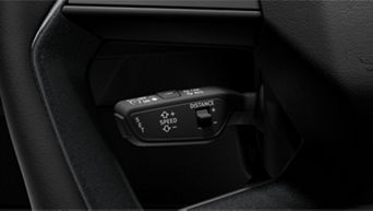 Car steering wheel with adaptive cruise control buttons on the left side.