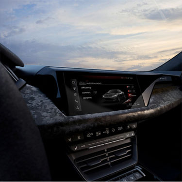 Interior view of a car showcasing its infotainment system and dashboard at dusk.