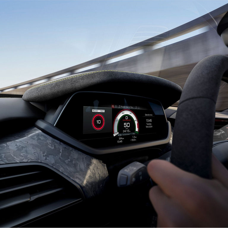 Driver's view of a modern car dashboard with digital displays showing speed and boost timer.