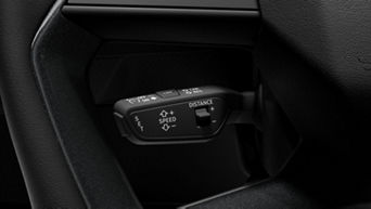 Car's steering wheel mounted cruise control and distance setting buttons with icons.