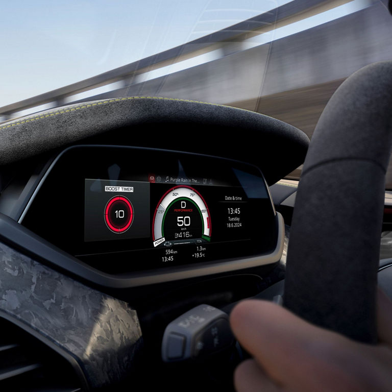 Digital car dashboard displaying speedometer and boost timer with driver's hands on wheel.