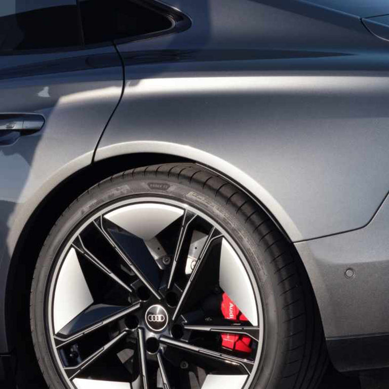 Close-up of a grey Audi RS e-tron GT rear wheel and taillight.