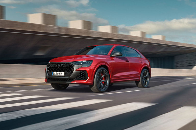 Red RS Q8 performance approaching a zebra crossing.
