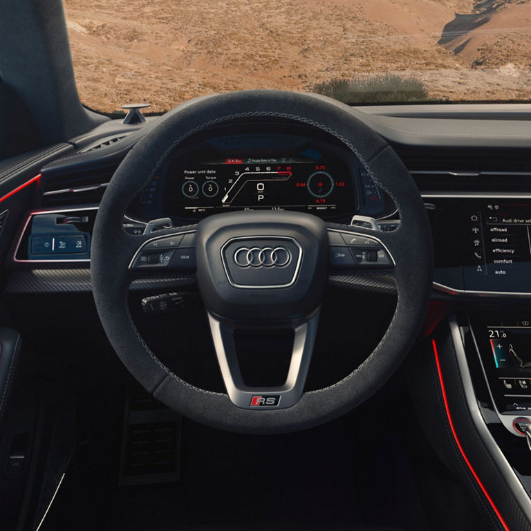 Interior view of Audi RS Q8 Performance steering wheel and dashboard controls.