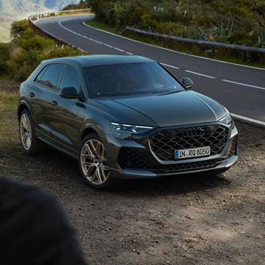 Front facing view of Audi RS Q8 parked off-road.