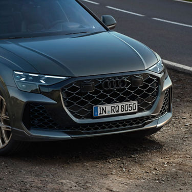 Cut away view of Audi RS  Q8 parked roadside on gravel.