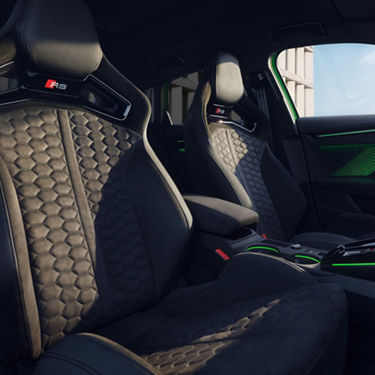 Audi RS3 Saloon car interior with high-end sports seats and ambient lighting.