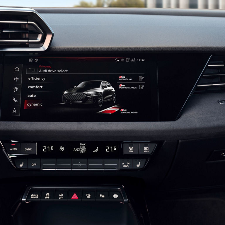 Car infotainment display showing Audi drive select options with climate control settings below.