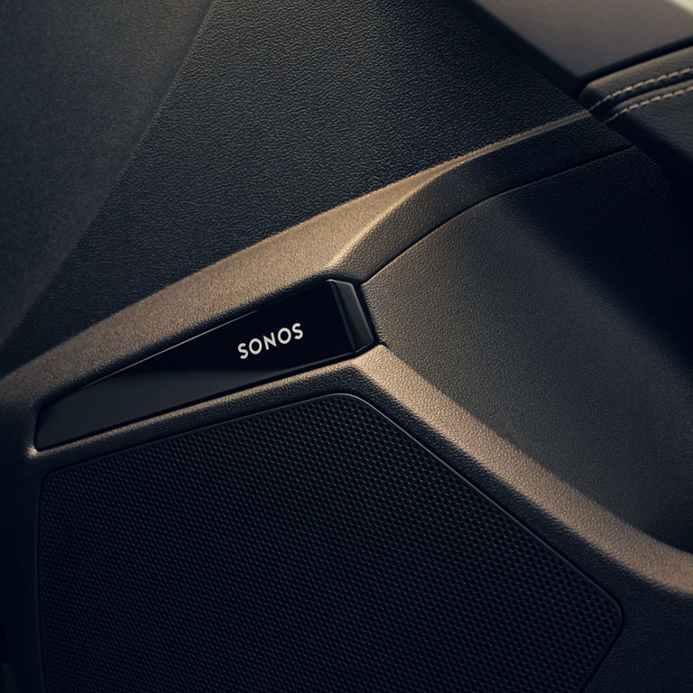 Close-up of a SONOS speaker system integrated into an Audi RS3 car door panel.