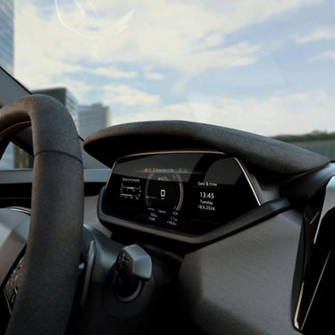 Digital dashboard of a car displaying speed, battery status, and navigation.