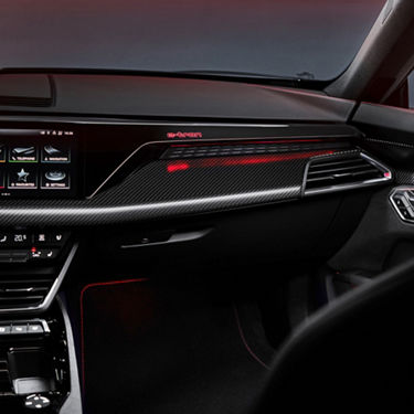 Interior view of a car with dashboard, touchscreen display, and ambient lighting.