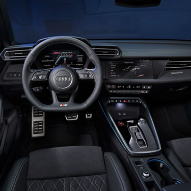 Interior view of an Audi car highlighting the steering wheel, dashboard, and center console.