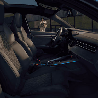 An Audi car interior with leather seats and a person standing outside.