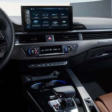 Modern car dashboard with touchscreen infotainment system and climate controls. 