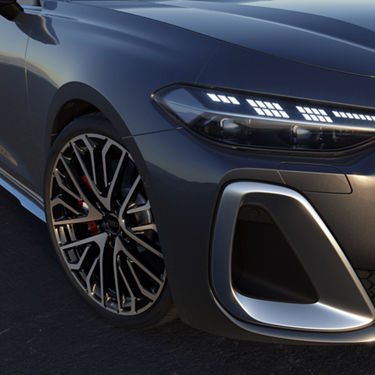 Close-up of a grey car's front wheel and headlight, showcasing intricate rim design and LED lights.