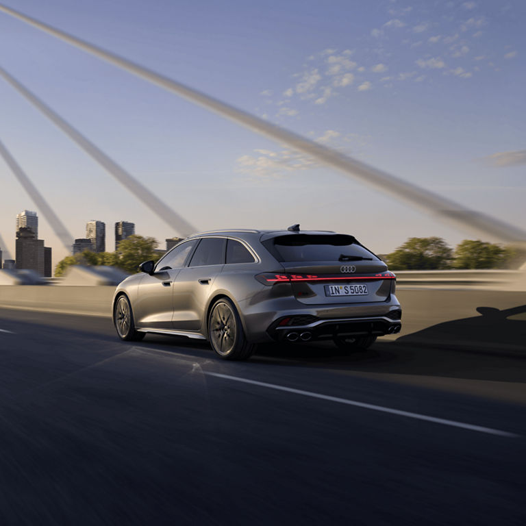 Silver Audi S5 Avant driving on highway with motion blur background.