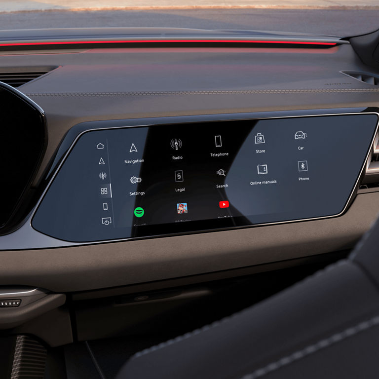 Car's interior with a touchscreen infotainment system dashboard.