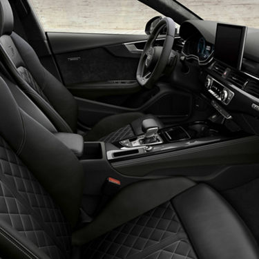 Car's interior with leather seats, touchscreen display, and modern dashboard.