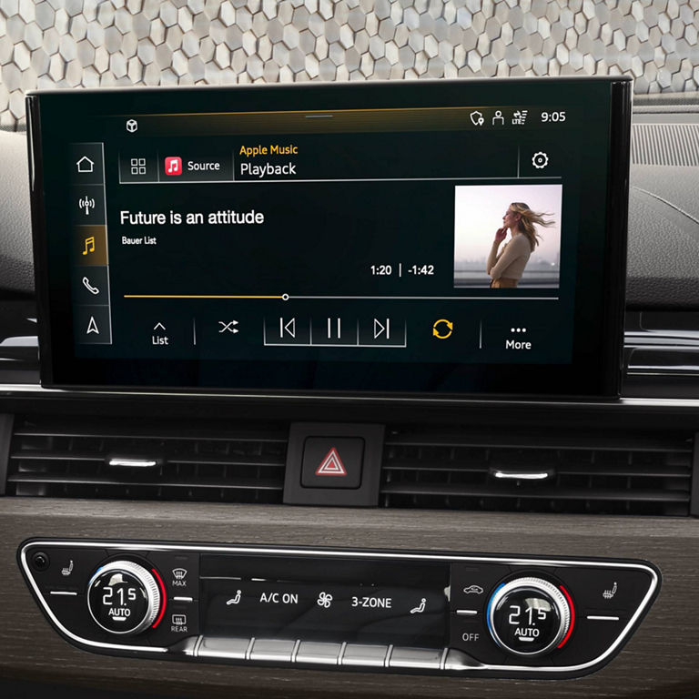 Car infotainment screen displaying music interface with a song title and playback controls.