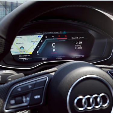 Digital dashboard display inside a car, showing navigation, speedometer, and temperature.