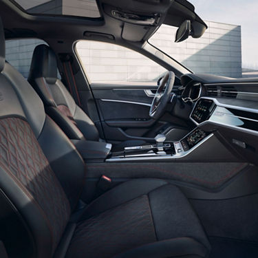 Car interior with modern dashboard, leather seats, and touchscreen display.